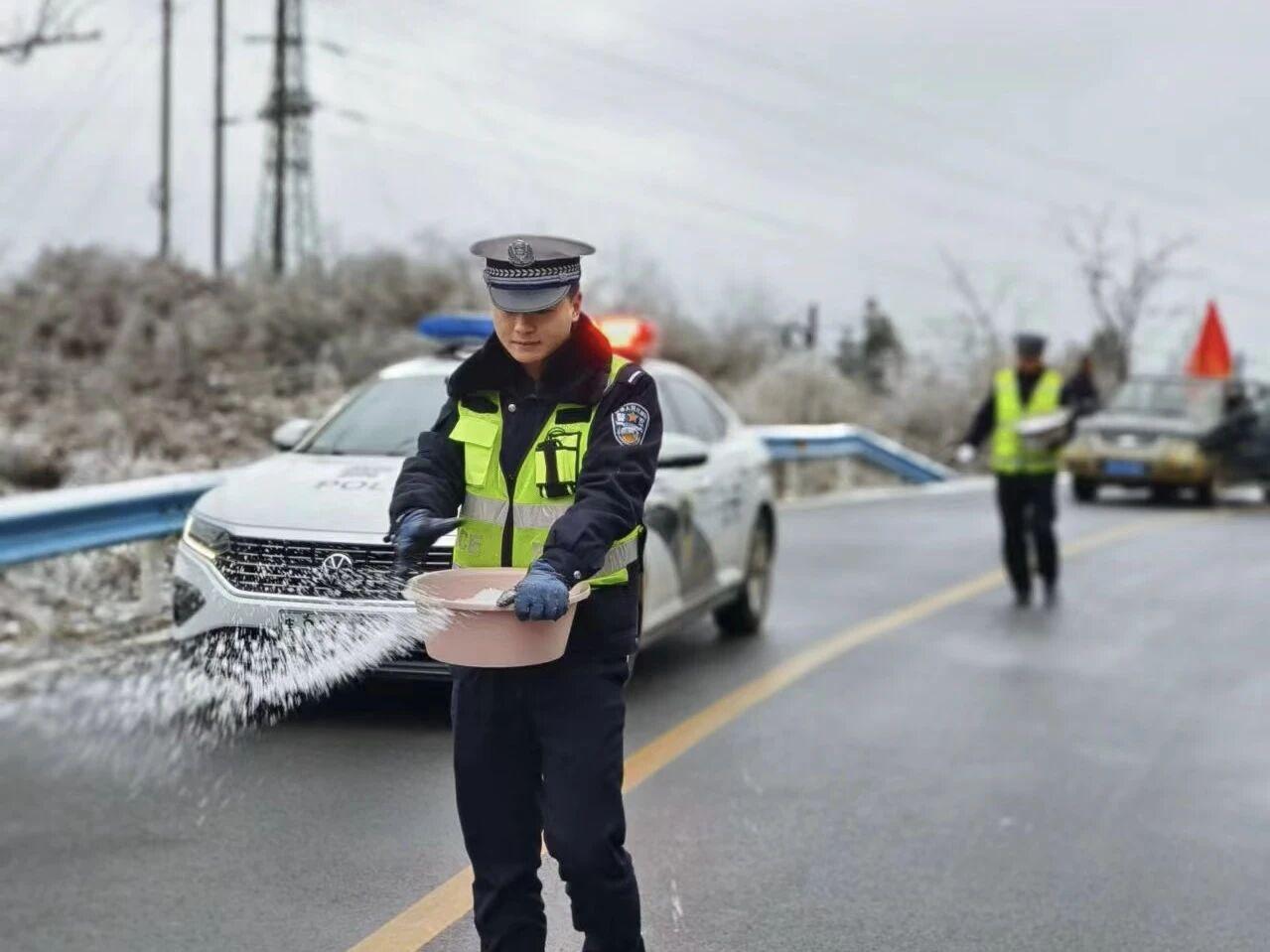 圖1民警在轄區(qū)結(jié)冰路段開展撒鹽除冰防凍工作。.jpg